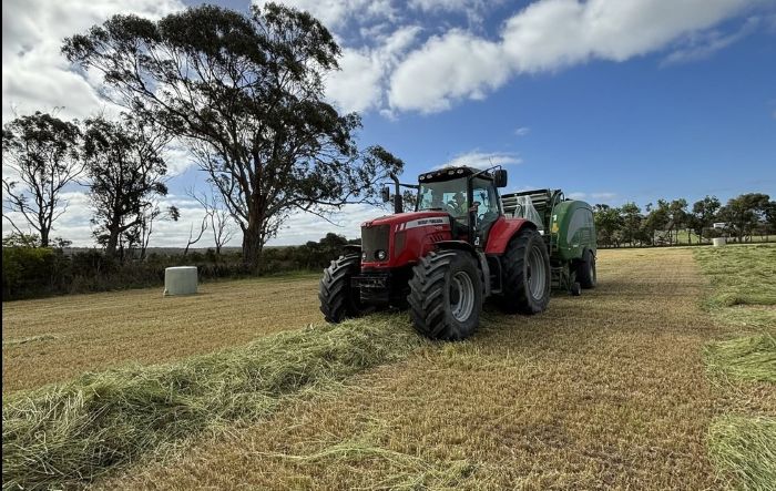Bowden’s Agricultural Contracting tractor and baler working in a paddock